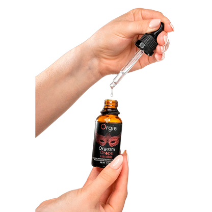 Application du gel Orgasm Drops Kissable Orgie, flacon compte-gouttes avec nuage rouge évoquant la sensualité - Oh My God'Z