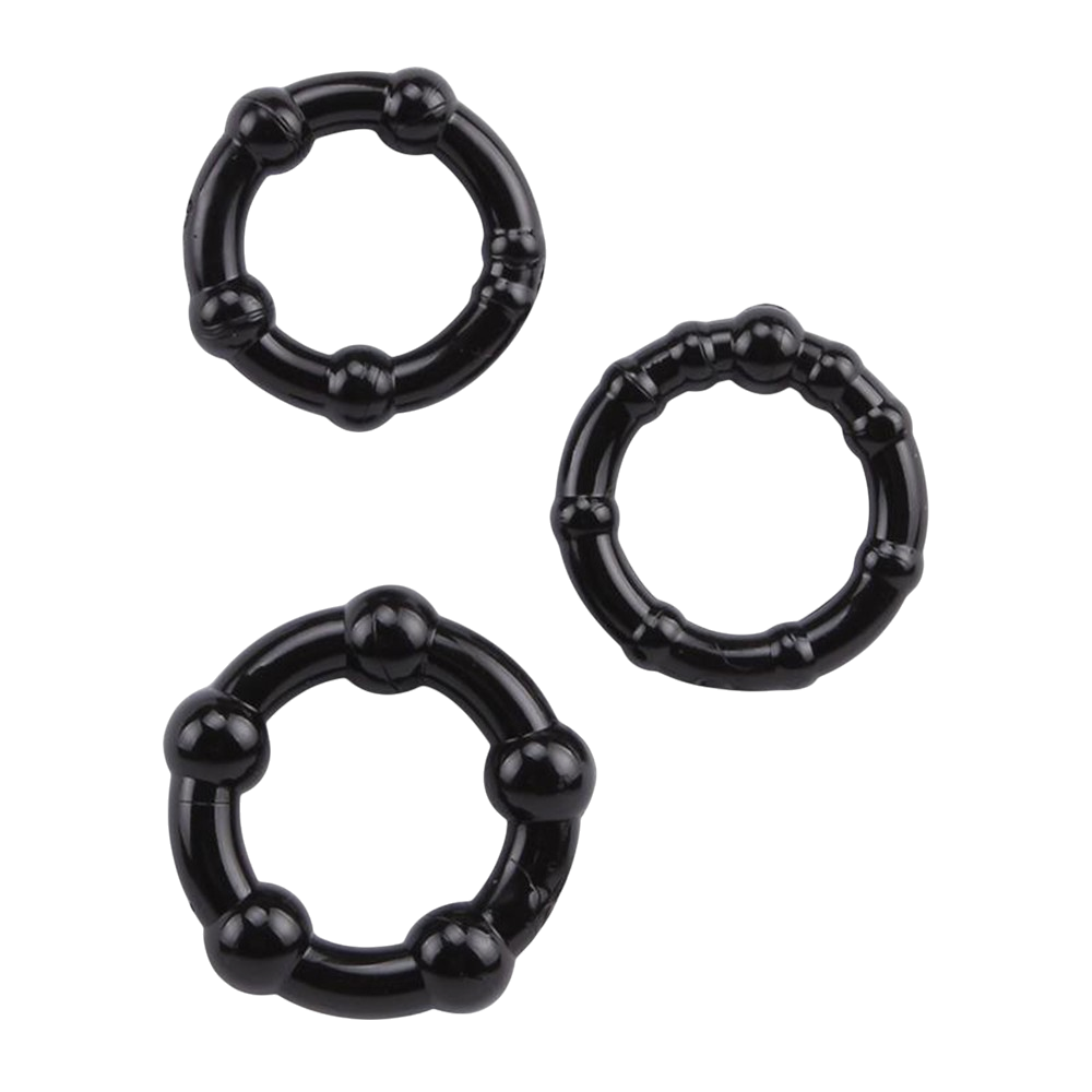 Trois cockrings noirs souples en TPR a billes de stimulation, de diametres differents, poses a plat - Oh My God'Z